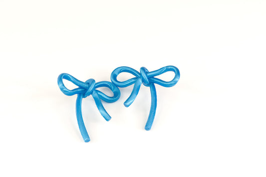 Bow-shaped earrings from the Coquette Collection, in cyan blue with a silk finish.