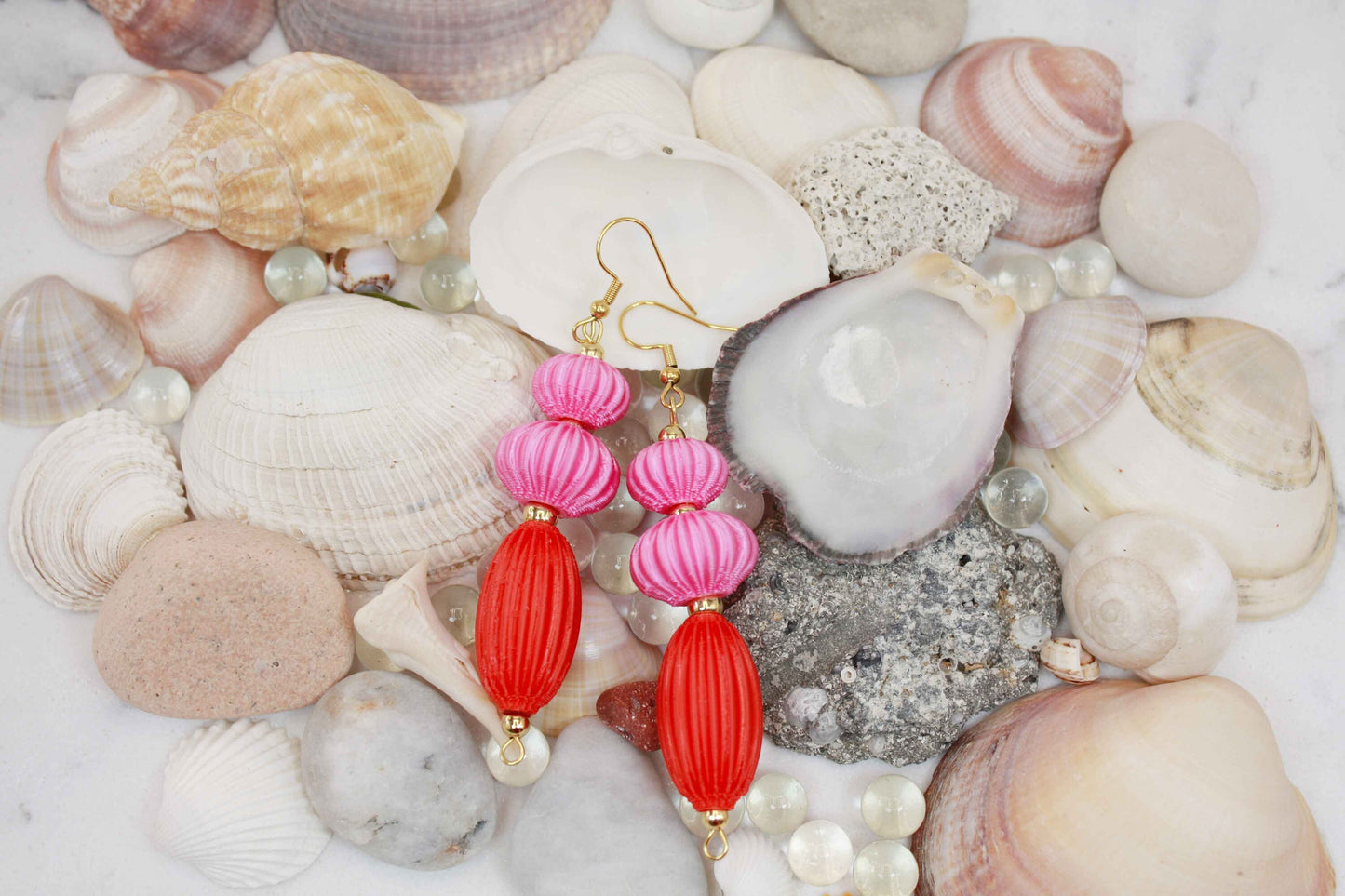 Anemone earrings from the Lukt collection, in vibrant pink and coral red, 3D printed, very light and sophisticated.