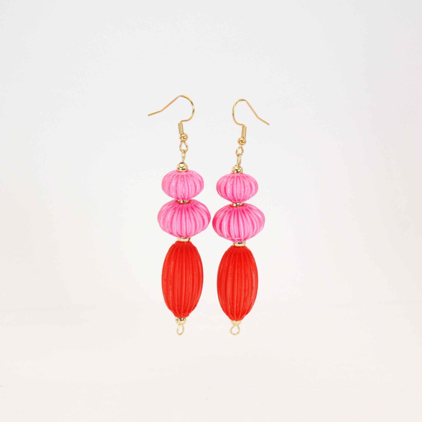 Anemone earrings from the Lukt collection, in vibrant pink and coral red, 3D printed, very light and sophisticated.