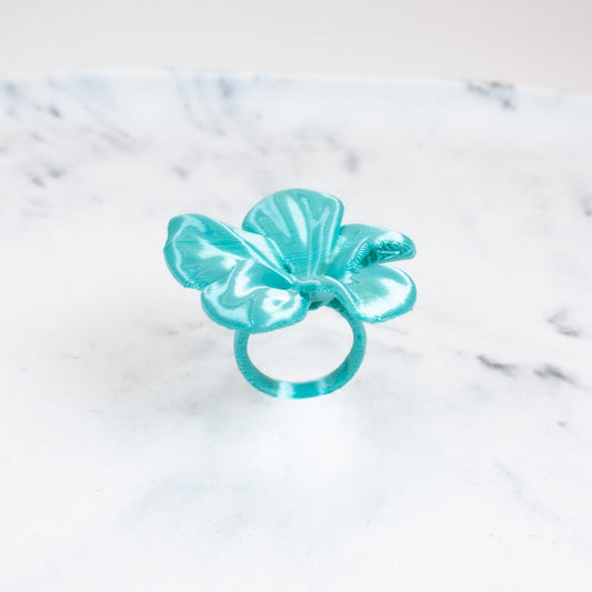 Custom-made 3D printed turquoise Hibis flower ring, available in various colors.